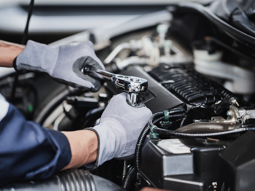 Mechanic carrying out an engine repair in the workshop